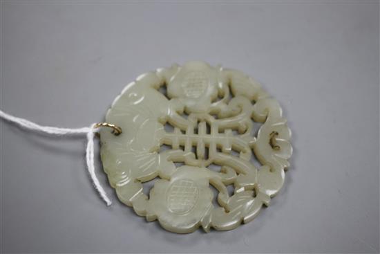 A Chinese pierced and carved pale celadon jade circular plaque pendant, 59mm, gross weight 23.5 grams.